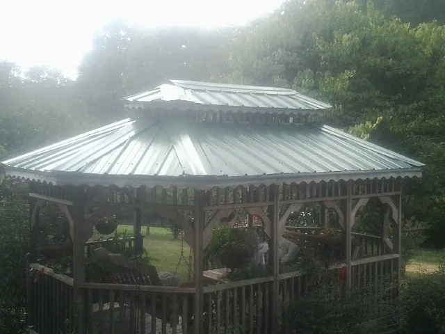 Two tier green metal roof on a garden gazebo in North Branch
